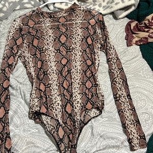 Snakeskin bodysuit. Snaps at bottom